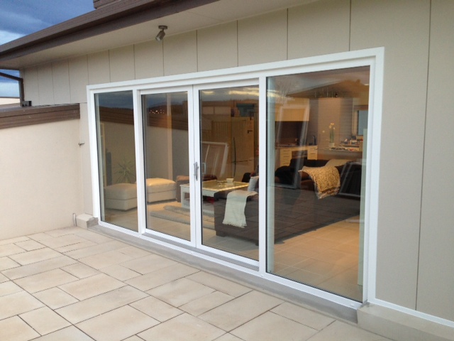 Double sliding door leading to tiled courtyard