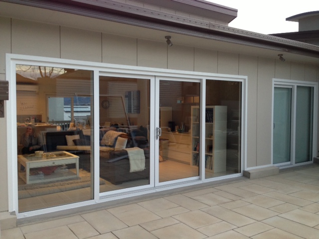 Double sliding door leading to tiled courtyard