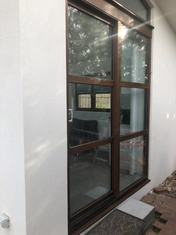White rendered home with glass sliding door