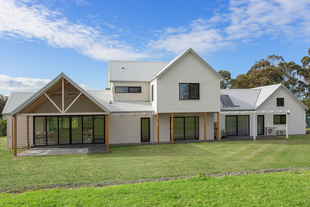 White weatherboard home with glass stacker doors