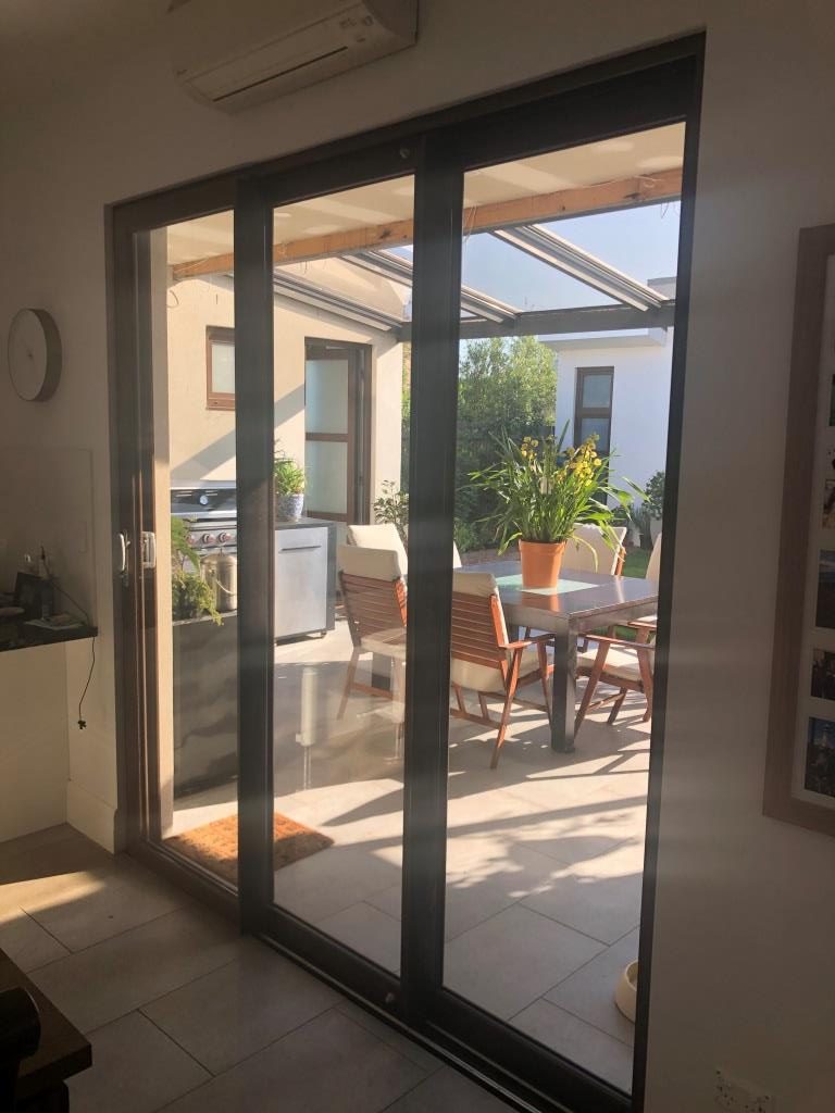 Glass stacker door from kitchen leading to patio