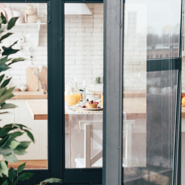 Glass window and doors leading into a kitchen and dining area